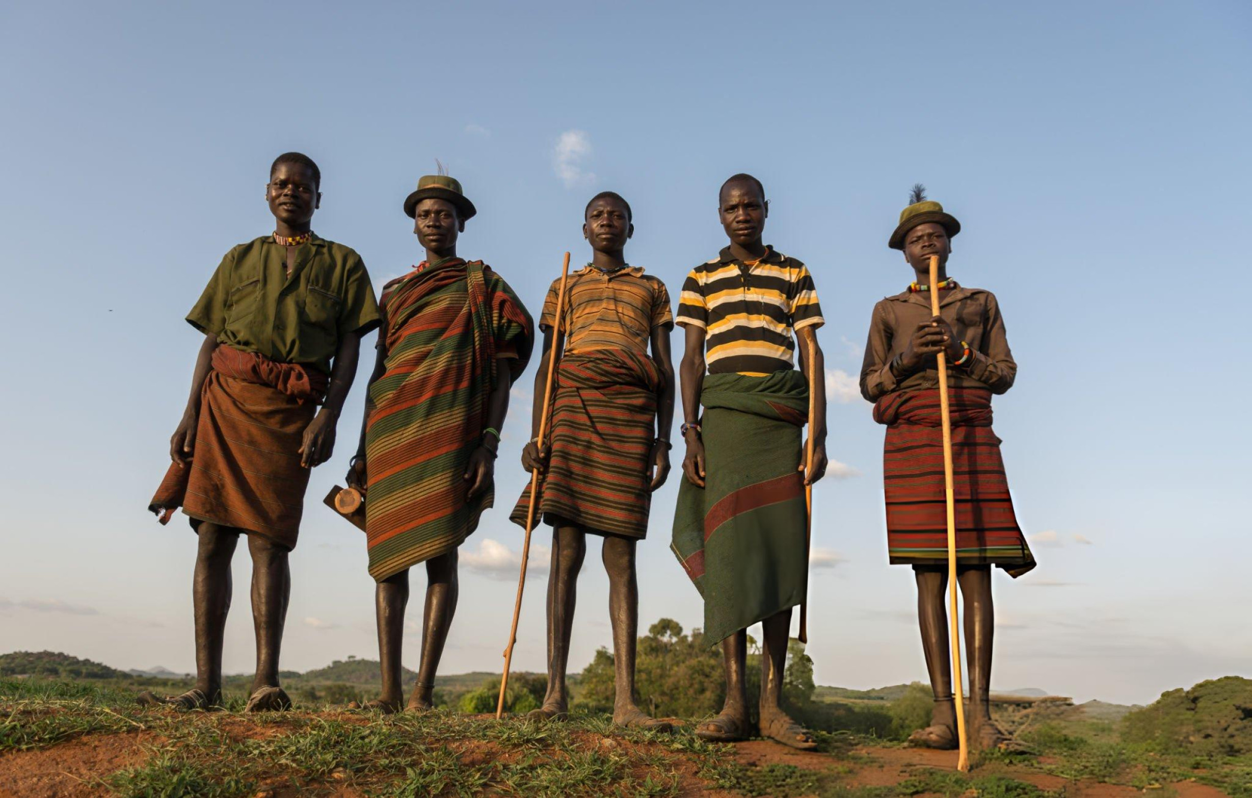 Woman in a village scene in warm light, reflecting authentic community connection.