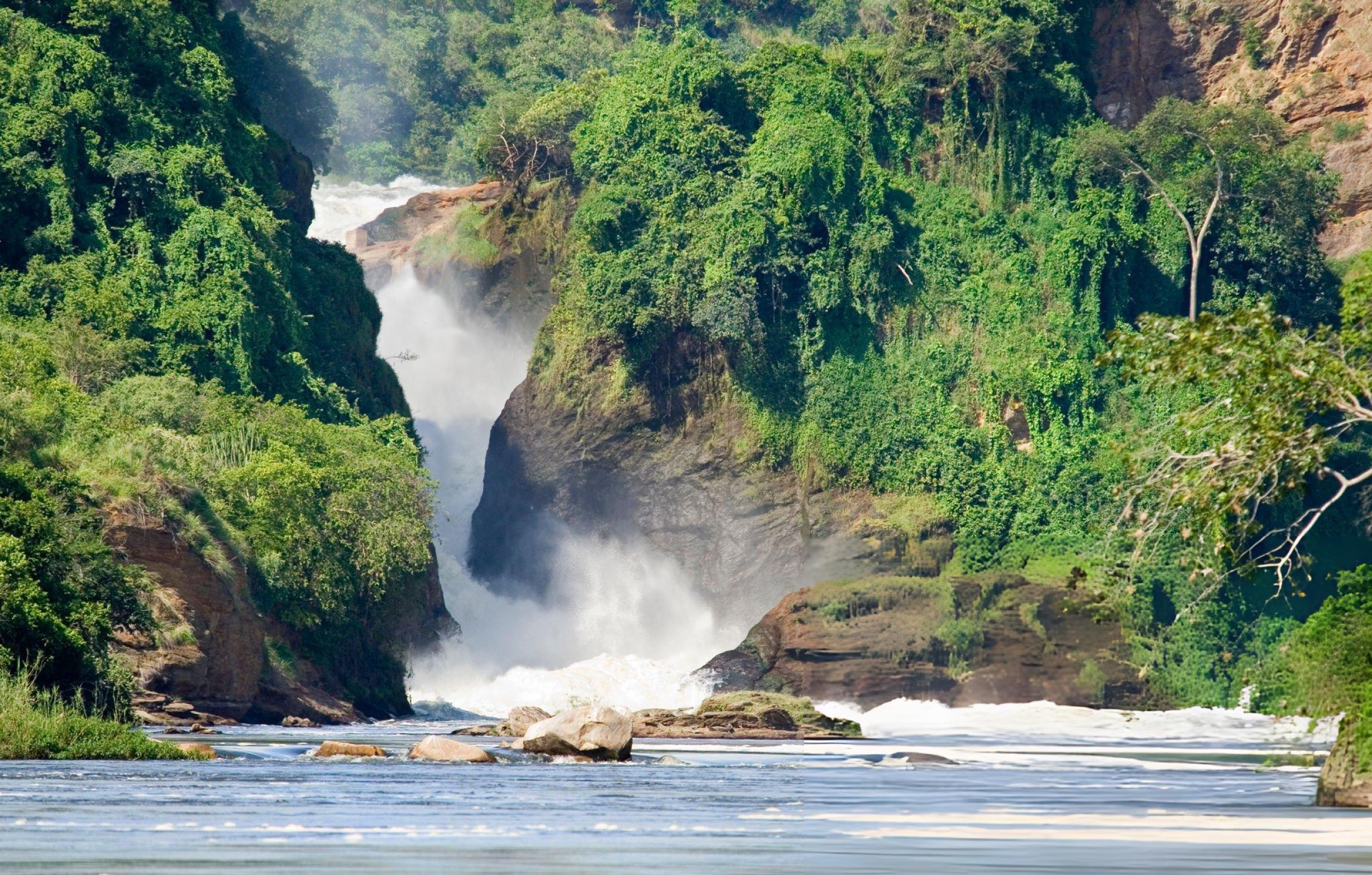 Open safari vehicle at golden hour overlooking a vast African landscape.